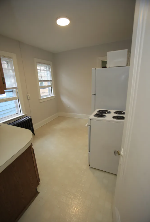 a kitchen with a refrigerator and a stove in it